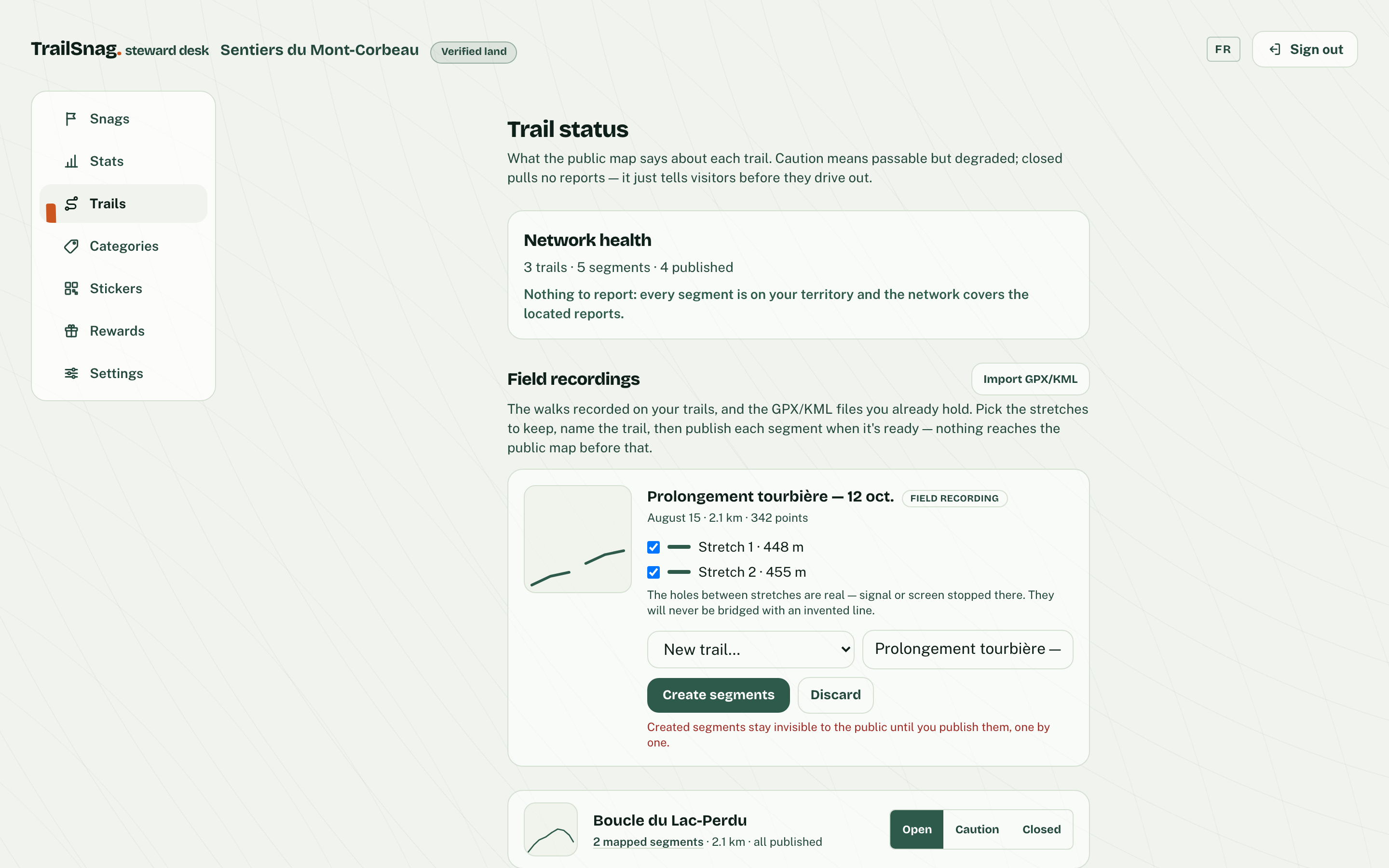 The trails screen: the network report, a captured walk waiting to be promoted with its two stretches, and each trail’s open/caution/closed status.